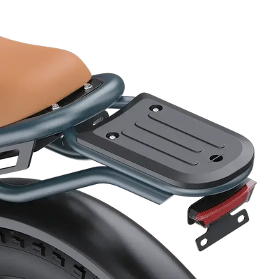 Close-up of black metal rear luggage rack with four mounting holes on electric scooter seat