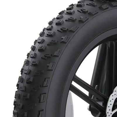 Close-up of 20-inch wide knobby tire for mountain bike with black spokes and disc brake