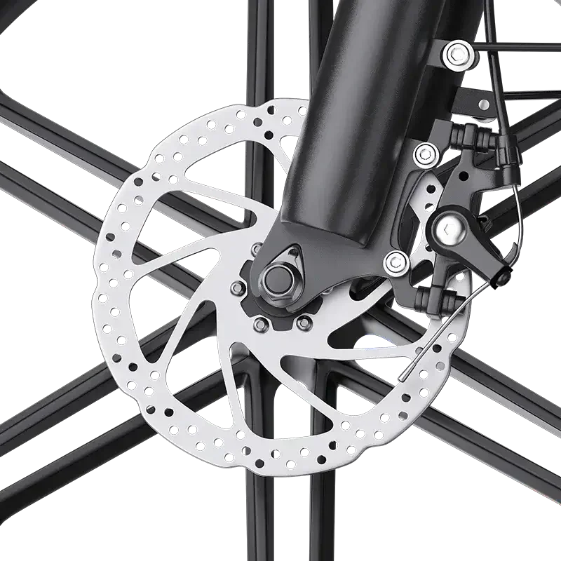 Close-up of a bicycle disc brake with a perforated rotor and black caliper on black spokes