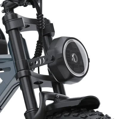Close-up of electric scooter front suspension and round LED headlight with black frame and thick tire